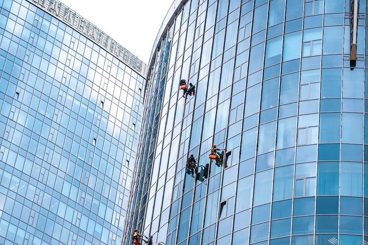 Workers washing windows in the office building